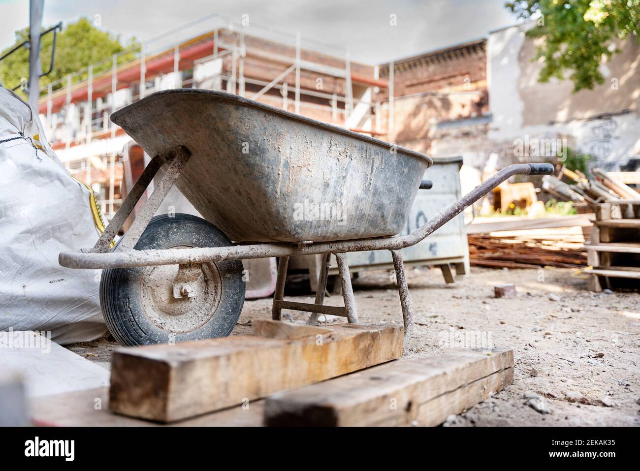 Wheelbarrow with construction material at construction site Stock Photo