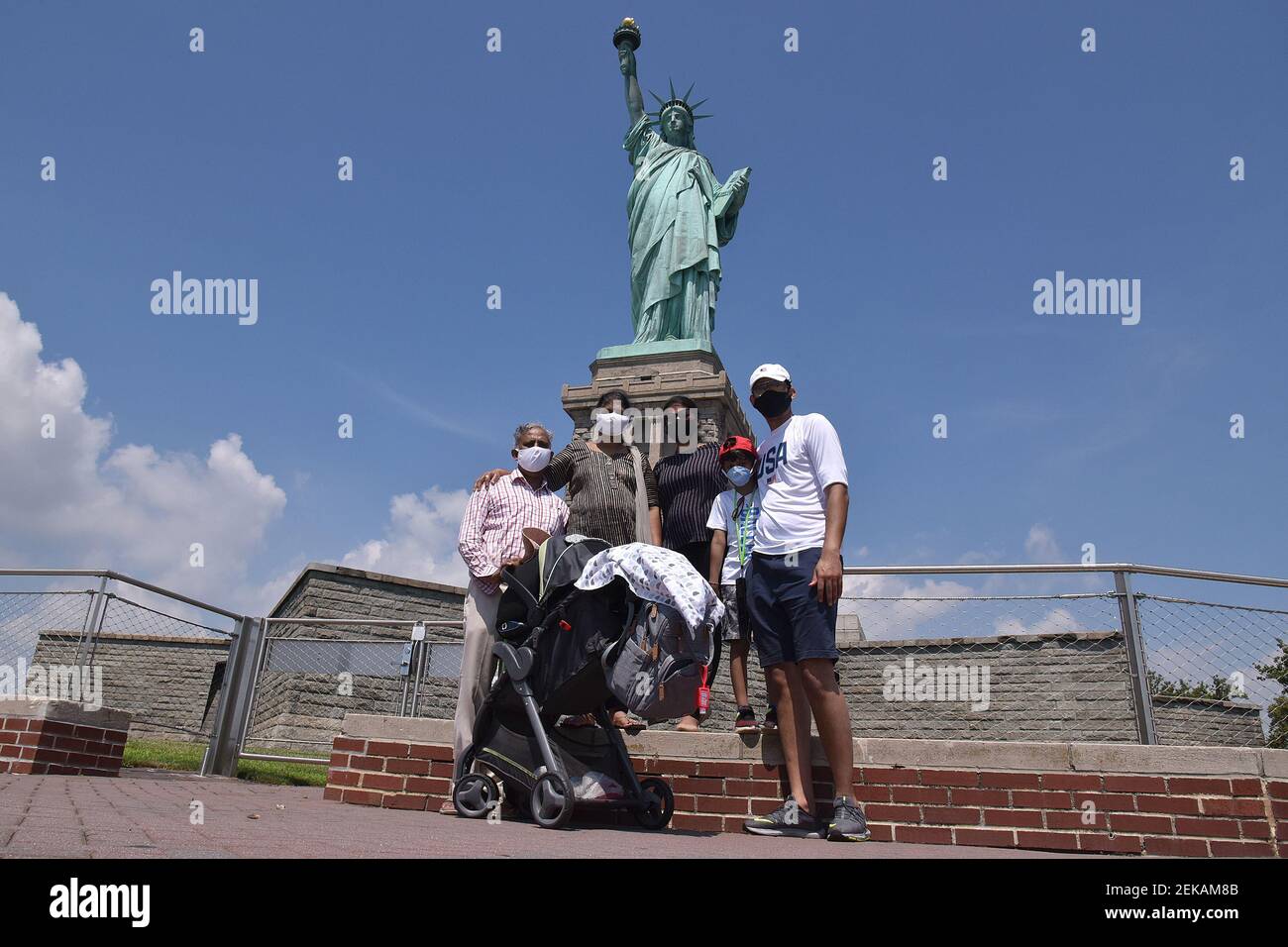 The Awal family, from Philadelphia, pose in front of the Statue of