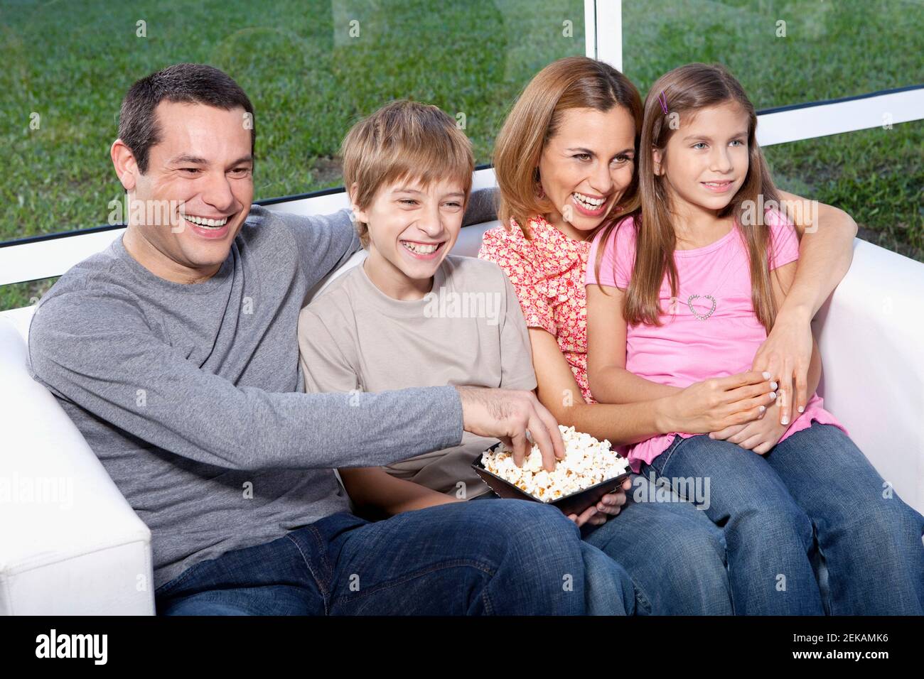 Family sitting on a couch Stock Photo