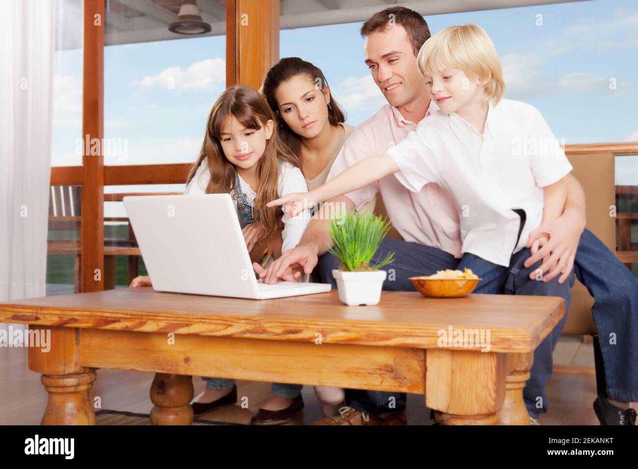 Family using a laptop at home Stock Photo - Alamy