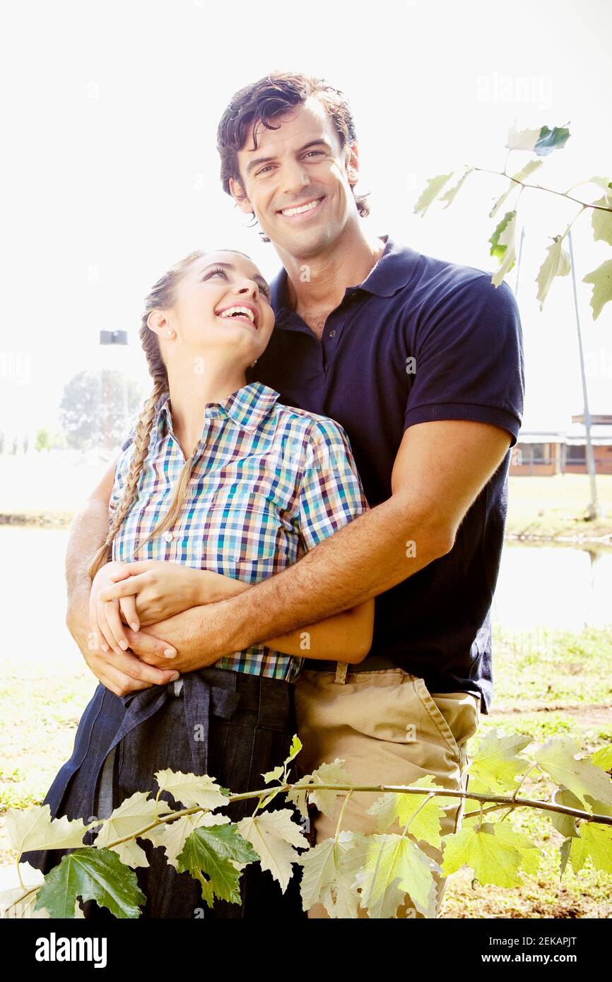 Man hugging a woman from behind Stock Photo - Alamy