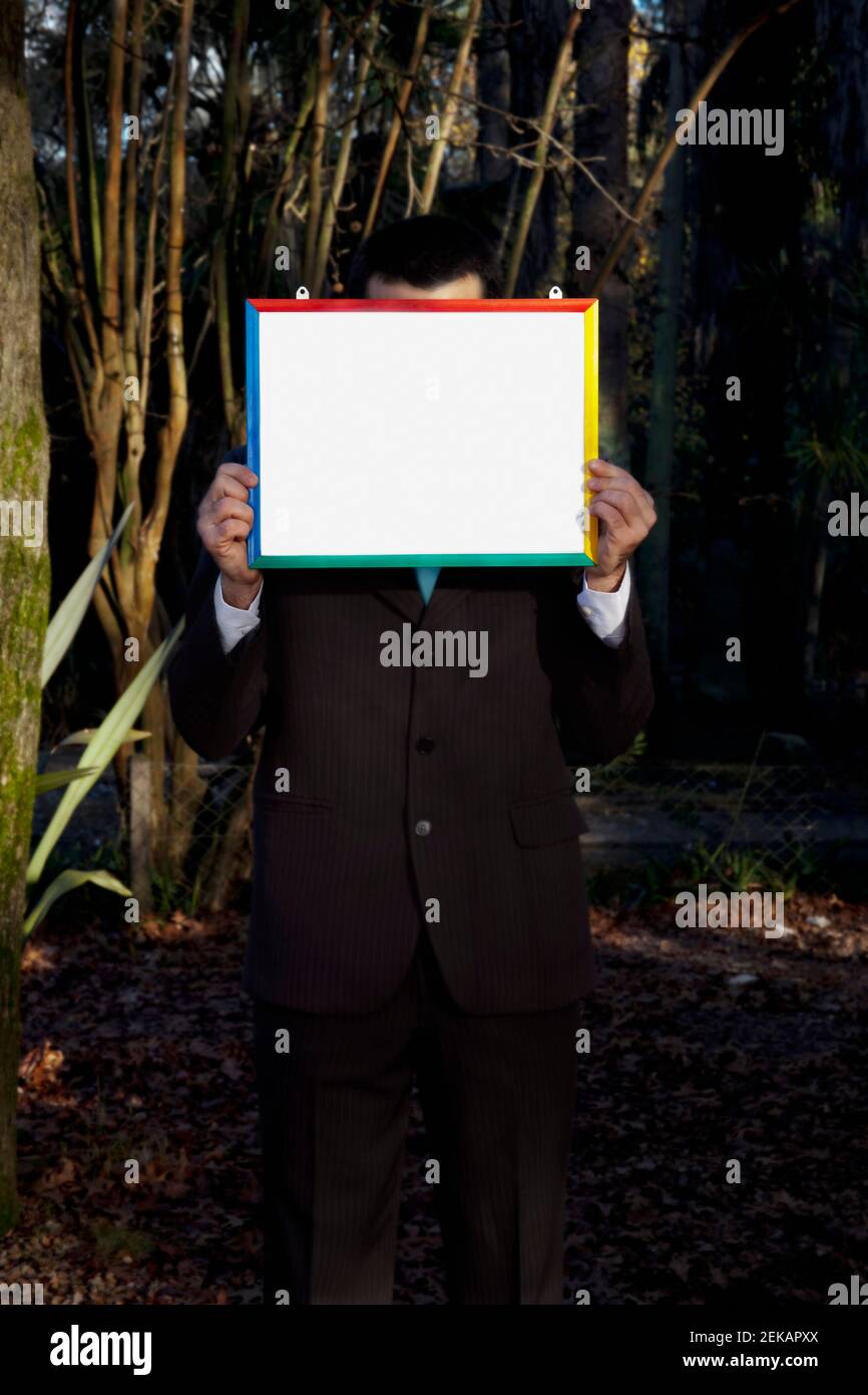 Businessman holding a blank placard Stock Photo