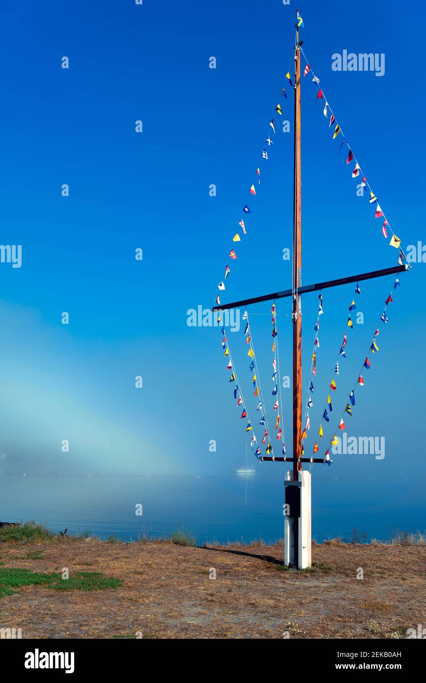 Many flags standing against a blue sky. Stock Photo