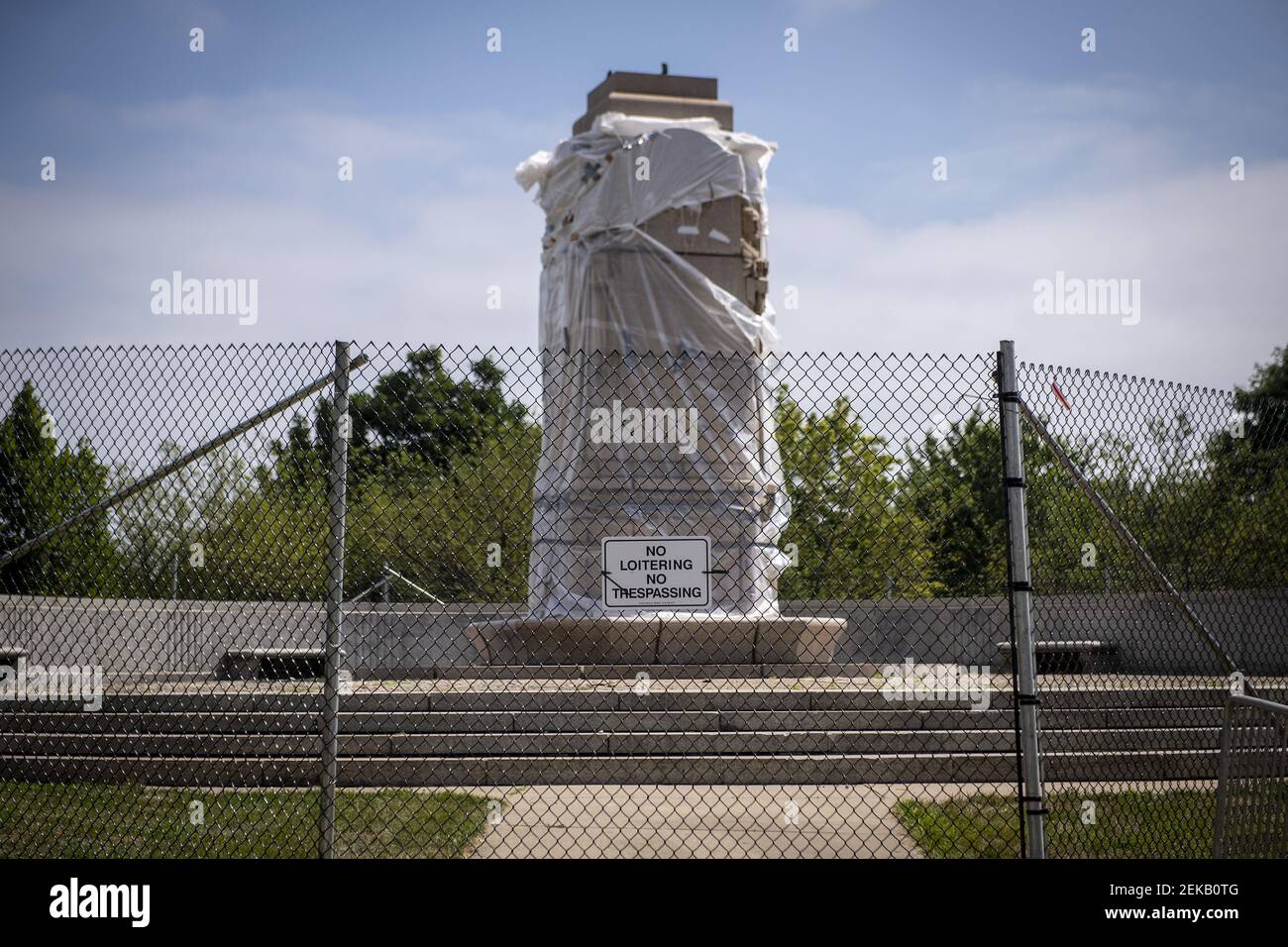 Fencing surrounds the empty pedestal of the Christopher Columbus statue