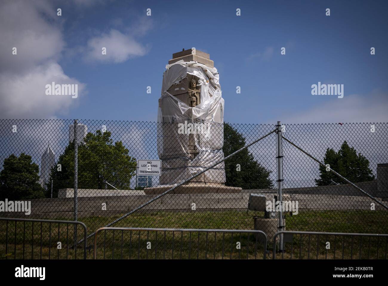 Fencing surrounds the empty pedestal of the Christopher Columbus statue
