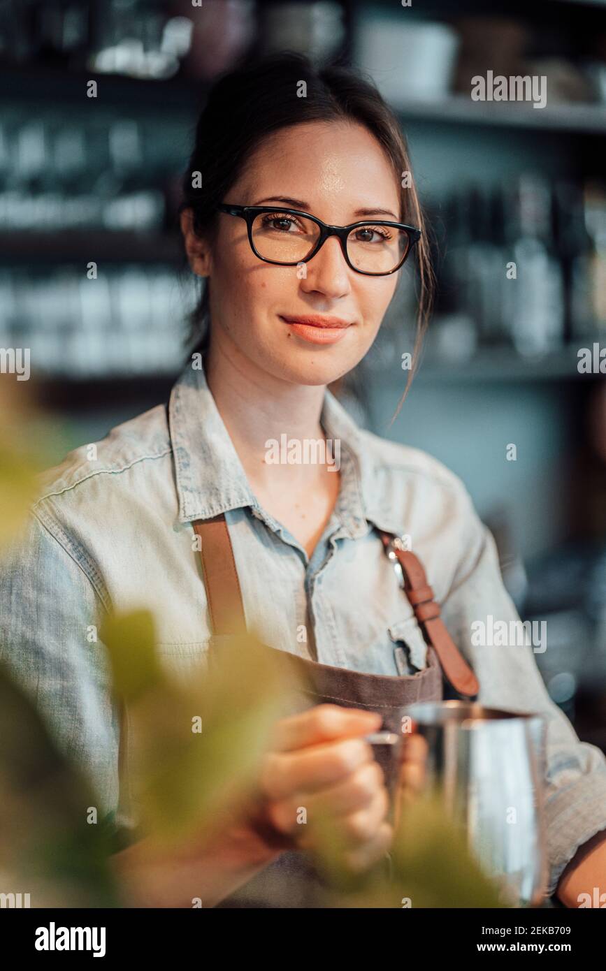Confident female owner with coffee pot in cafe Stock Photo Alamy
