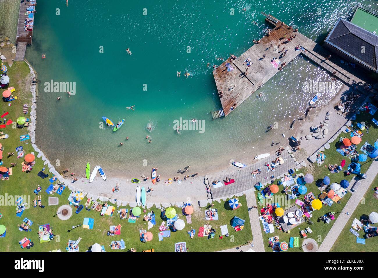 Austria, Salzburg, Sankt Gilgen, Aerial view of large group of people sunbathing along sandy shore of Lake Wolfgang Stock Photo