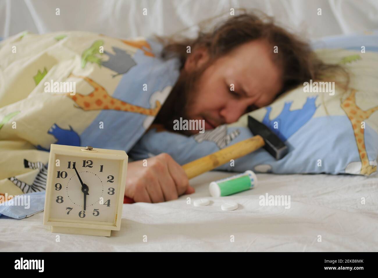 Sleeping man with a hangover. Funny sleeping man with hammer and headache pills and alarm clock in front of him. Symbol of hangover, headache and earl Stock Photo - Alamy Sleeping man with a hangover. Funny sleeping man with hammer and headache pills and alarm clock in front of him. Symbol of hangover, headache and earl Stock Photo - Alamy