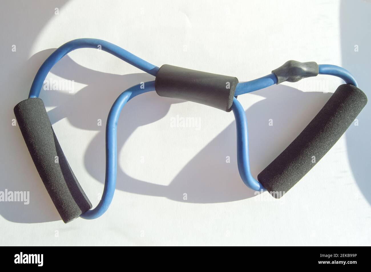 Back in action Modern rubber chest expander on white background Stock