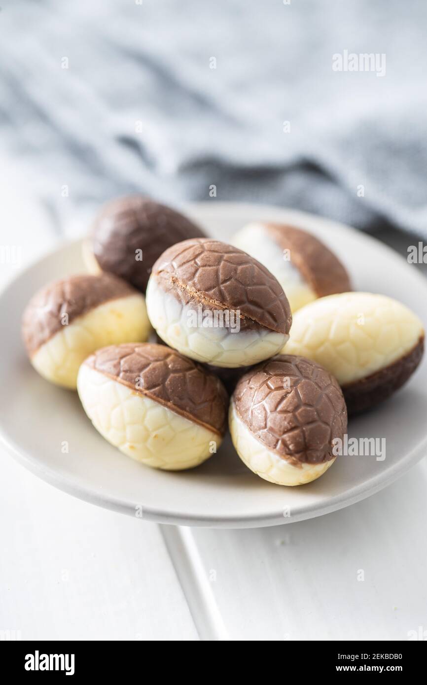 Chocolate easter eggs. Sweet candy eggs on white table. Stock Photo