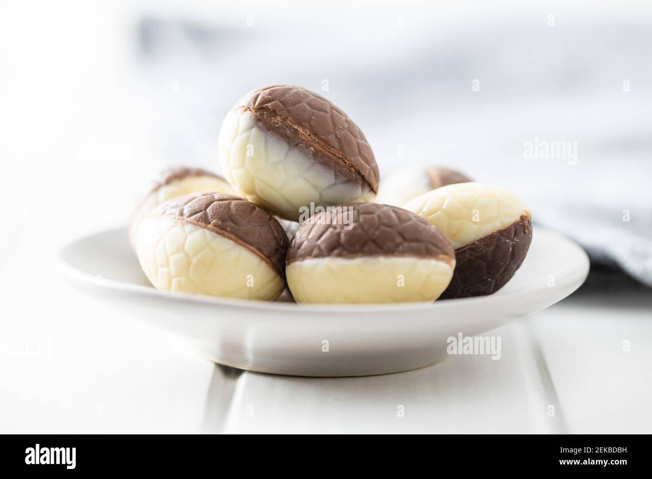 Chocolate easter eggs. Sweet candy eggs on white table. Stock Photo