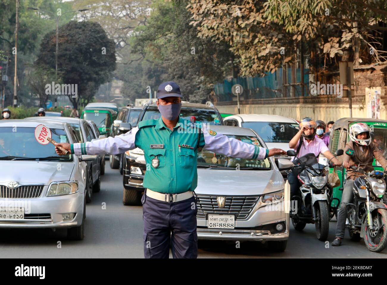 Dhaka, Bangladesh February 23, 2021 The traffic police is controlling the vehicles with their