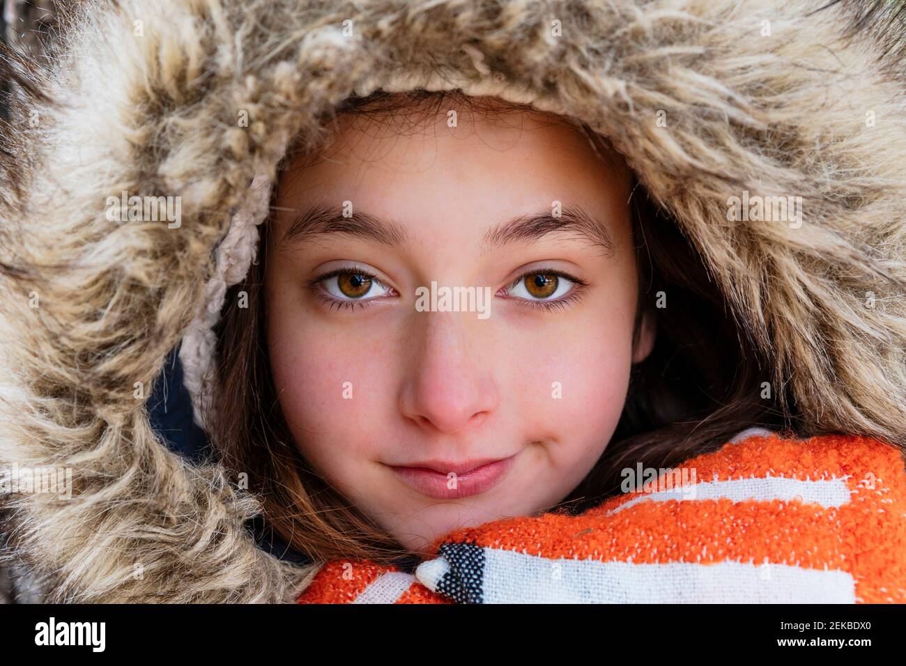 Close-up portrait of girl wearing fur coat Stock Photo