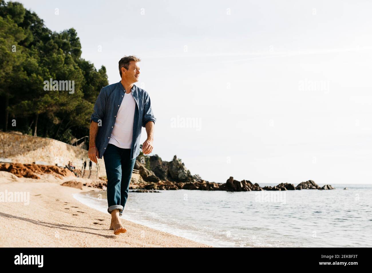 Man walking on beach hi-res stock photography and images - Alamy
