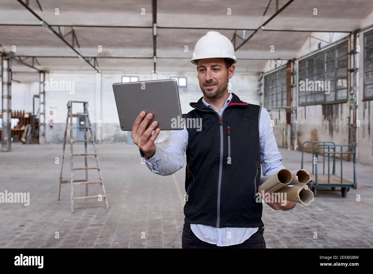 Male real estate developer using digital tablet while working in building Stock Photo