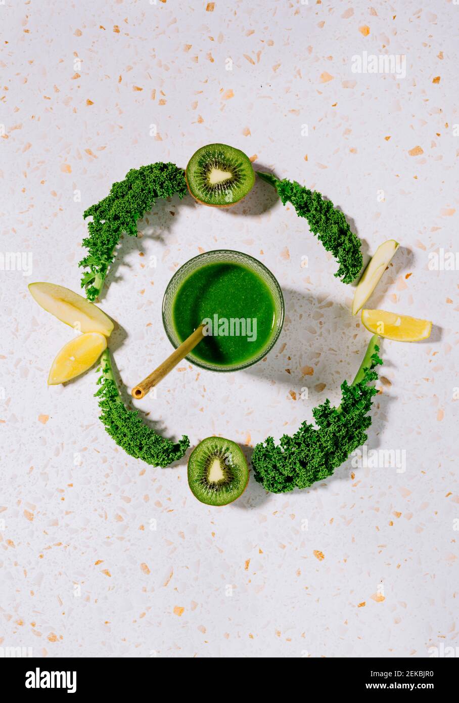 Healthy summer green juice with apple, lemon and kale on a modern