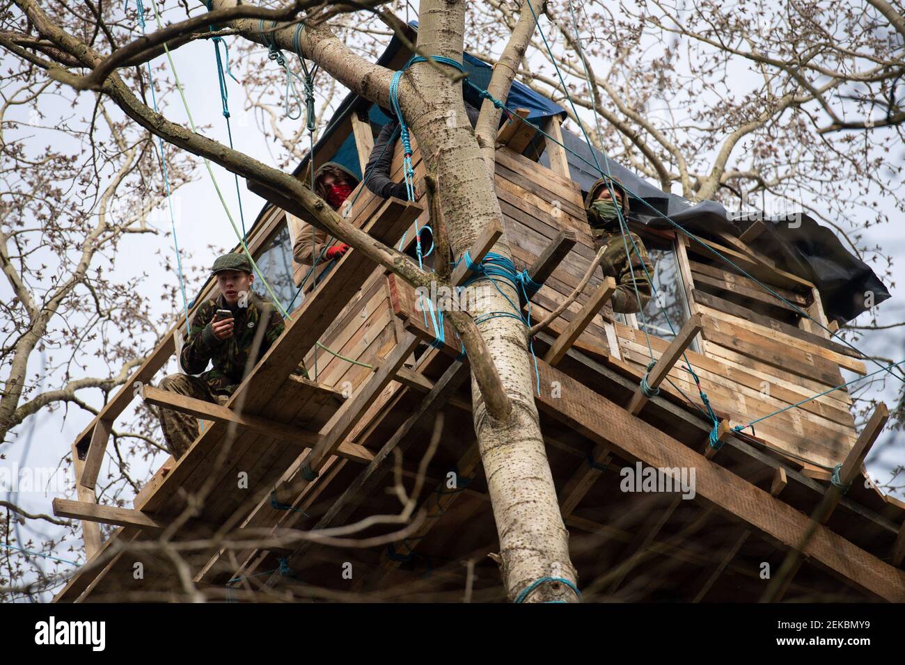 Anti-HS2 campaigners inside a treehouse, at an encampment in the ancient woodland at Poor's Piece Wood on the edge of Steeple Claydon in Buckinghamshire. Picture date: Tuesday February 23, 2021. Stock Photo