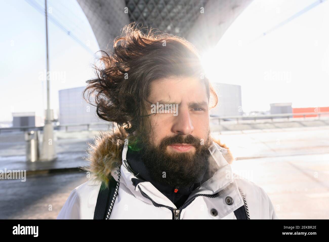 Male hipster wearing white parka during winter Stock Photo