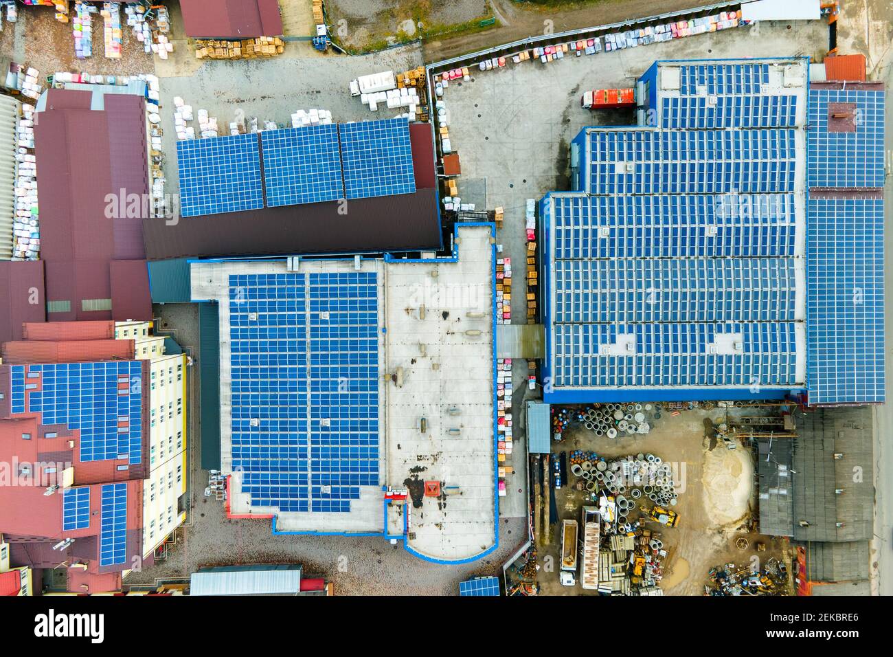 Blue photovoltaic solar panels mounted on industrial building roof for ...