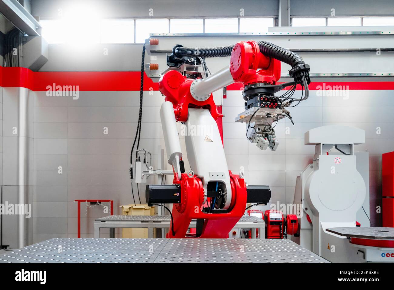 Red and white automatic welding robot in factory Stock Photo