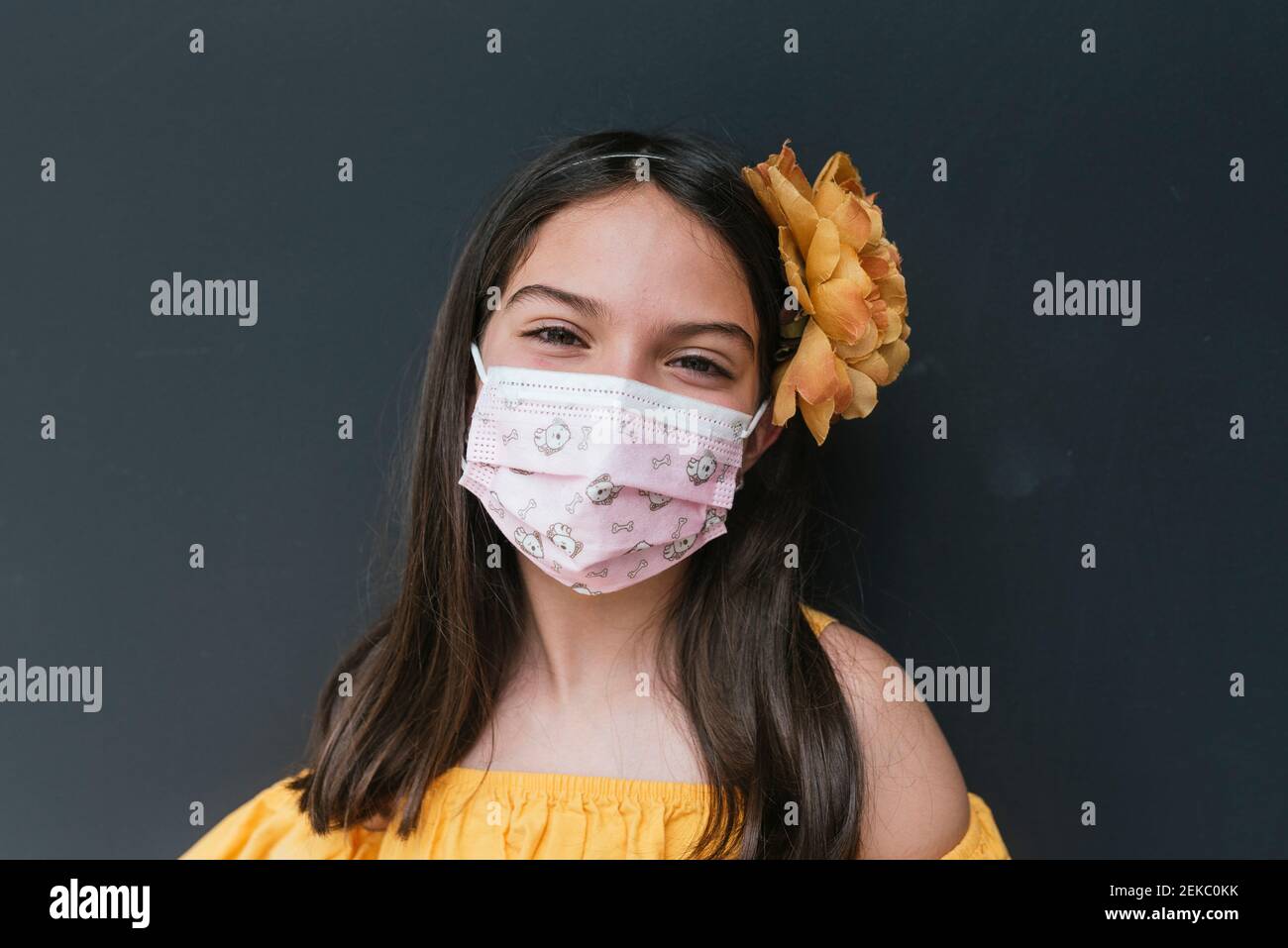 Closeup of girl wearing face mask against black background Stock Photo