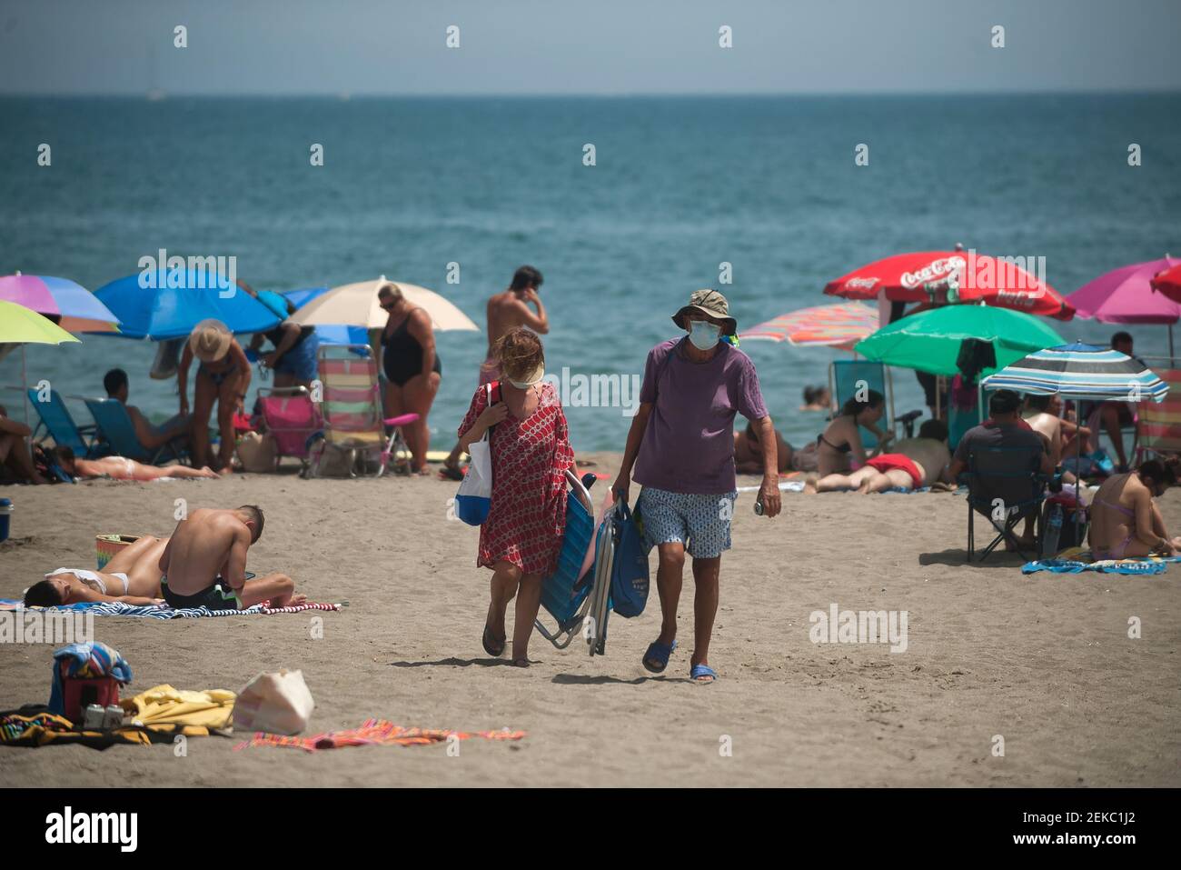 A couple wearing face masks seen leaving Rincon Sol beach of