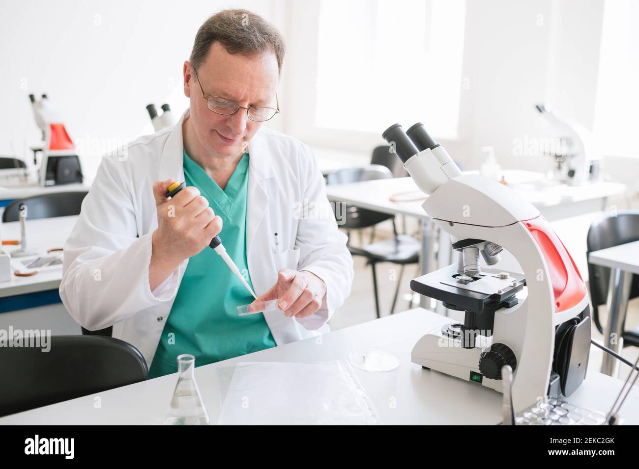 Researcher in white coat working in lab Stock Photo