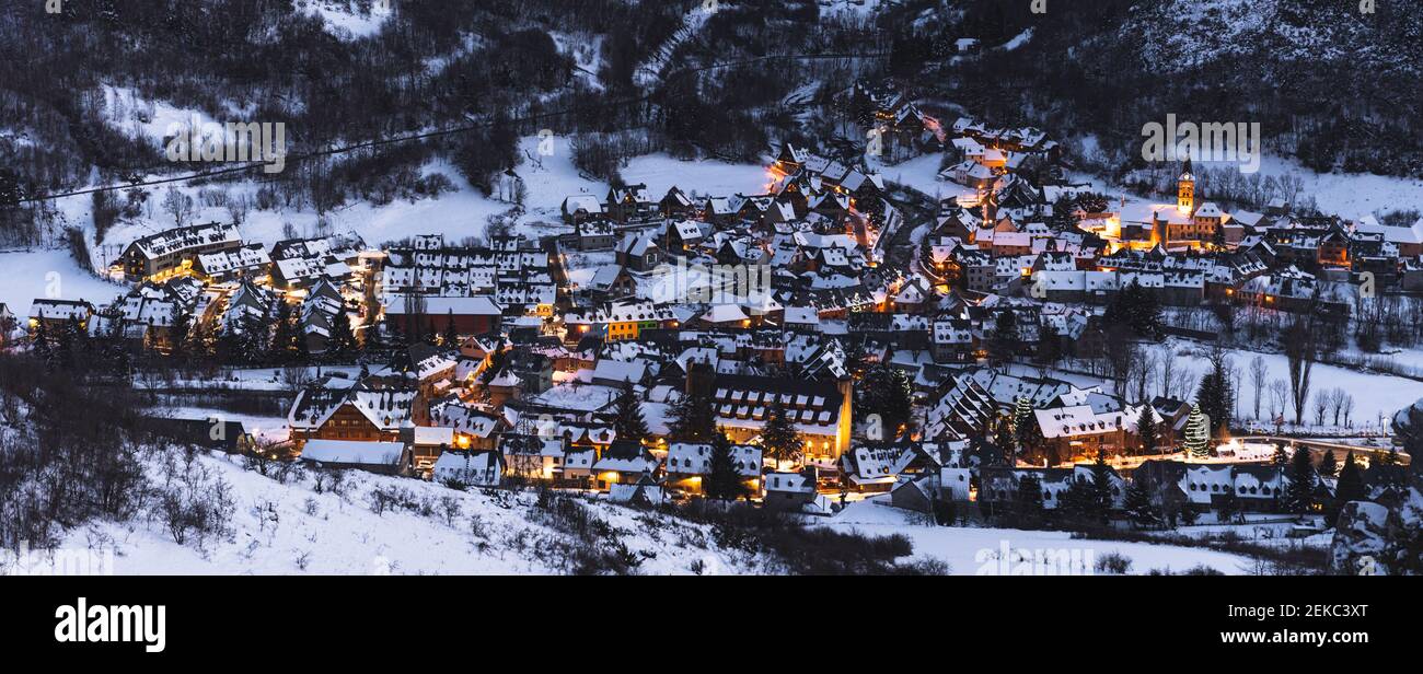 Spain, Cataluna, Baqueira, Ski resort covered with snow illuminated at dusk Stock Photo