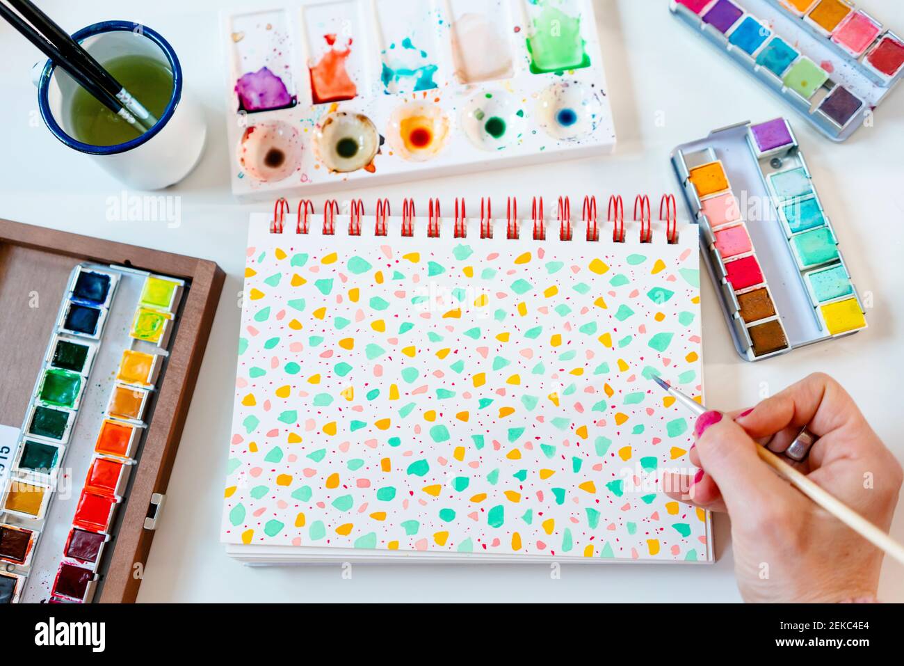Painting pastel colors terrazzo pattern with watercolors on spiral notebook Stock Photo