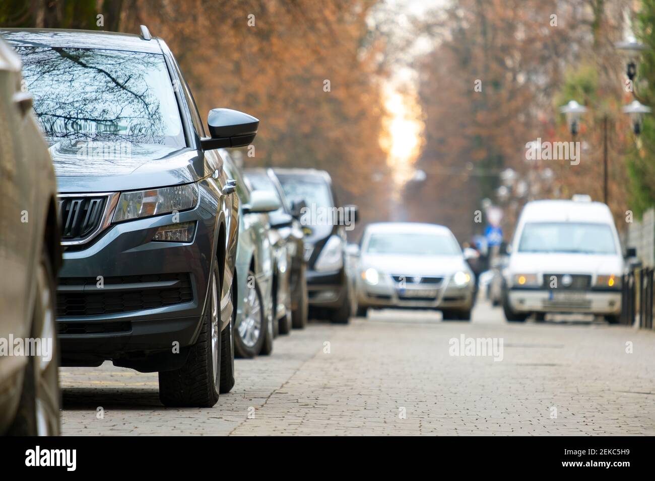 Cars parked in a row on a city street side Stock Photo - Alamy