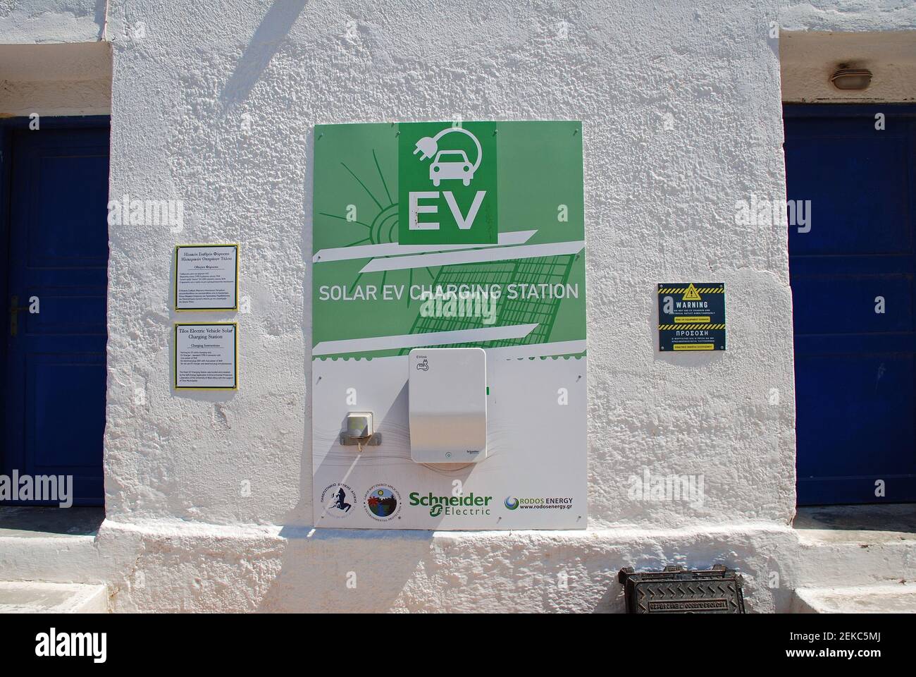A solar powered electric vehicle charging point at Livadia on the Greek island of Tilos on June 15, 2019. Stock Photo