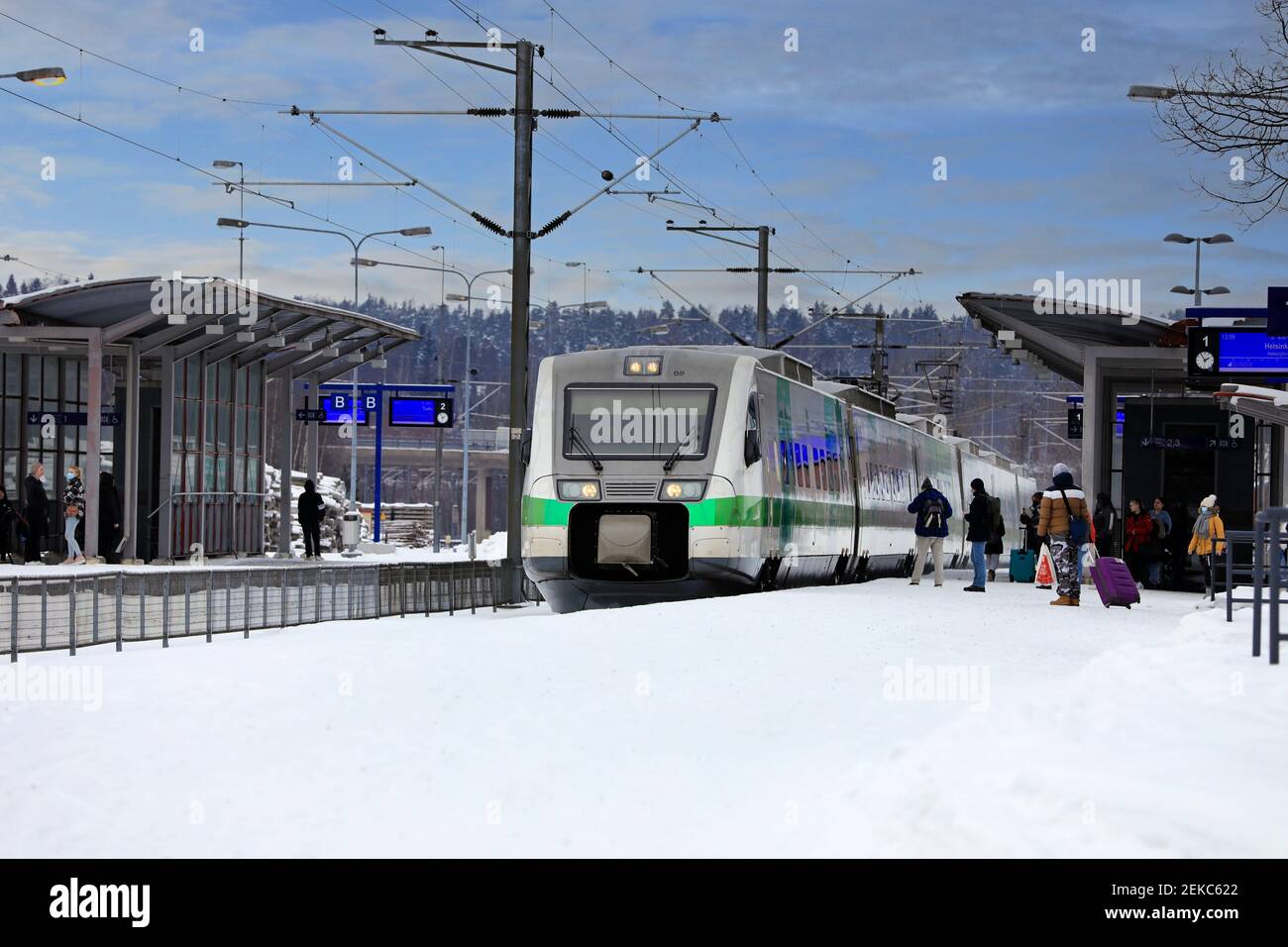 Passengers boarding Pendolino train on a winter afternoon in Salo