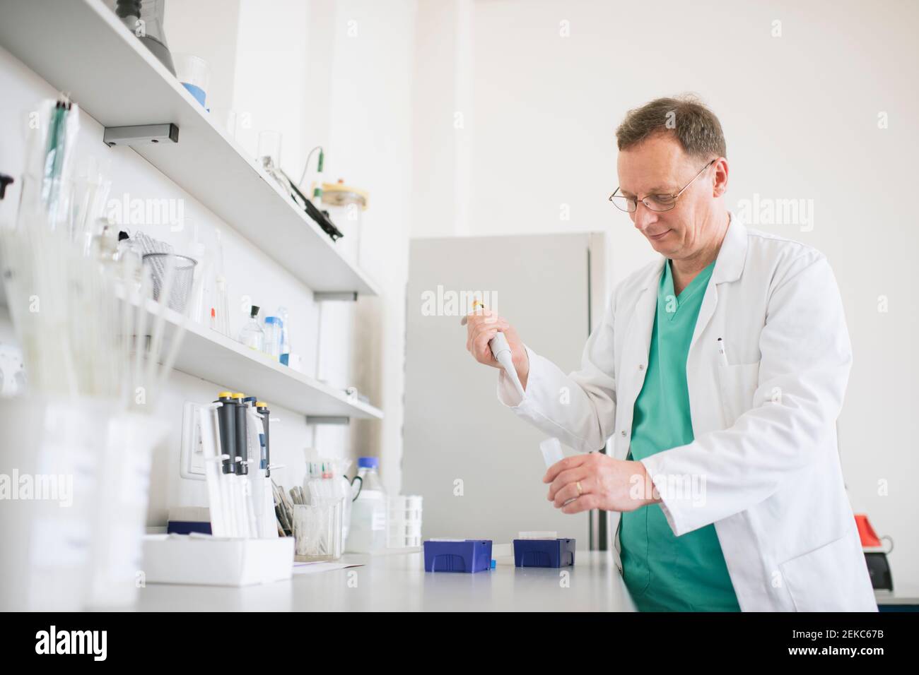 Researcher in white coat working in lab Stock Photo