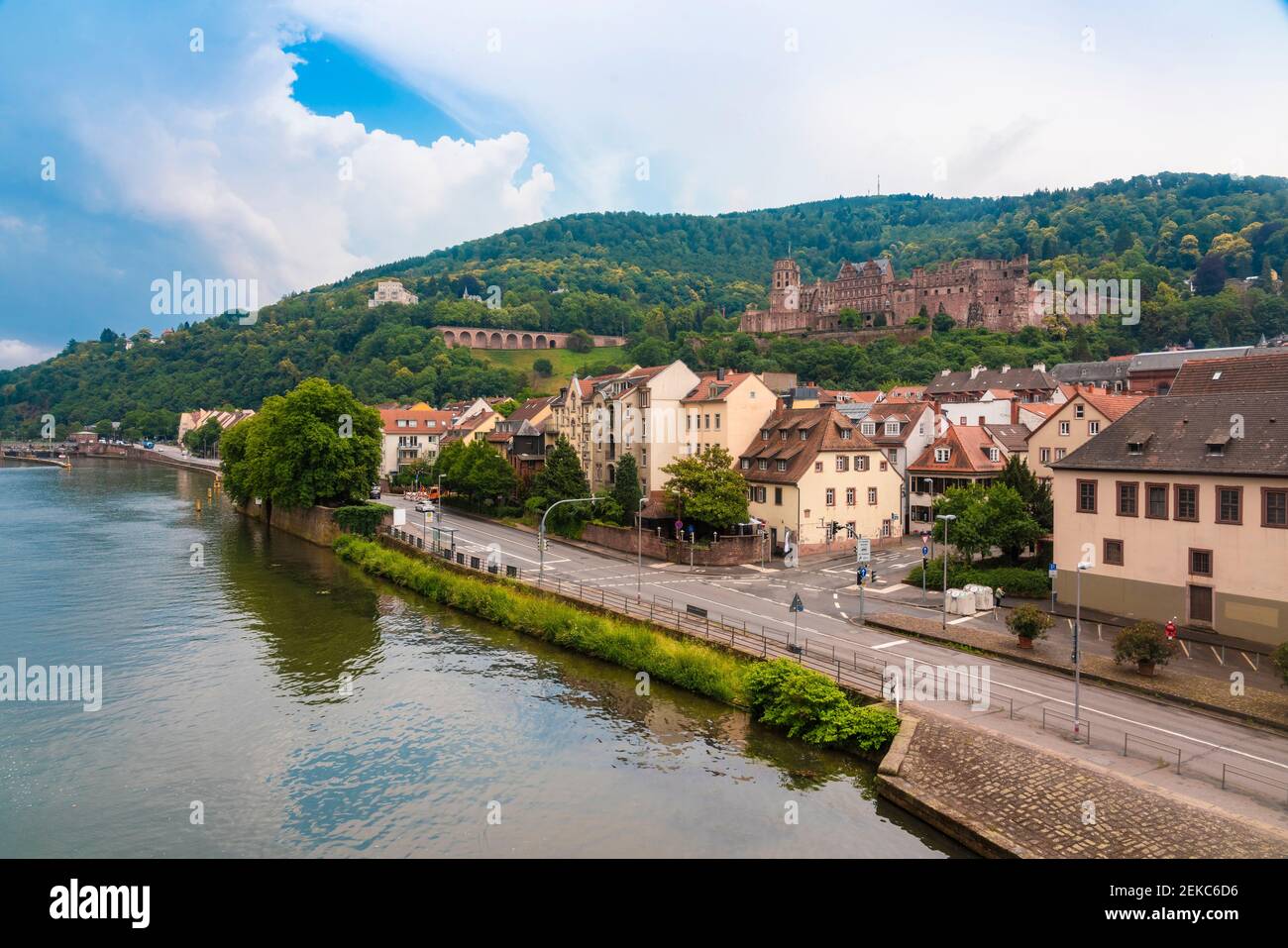 Germany, Baden-Wurttemberg, Heidelberg, Bank of Neckar with old town buildings and Heidelberg Castle in background Stock Photo
