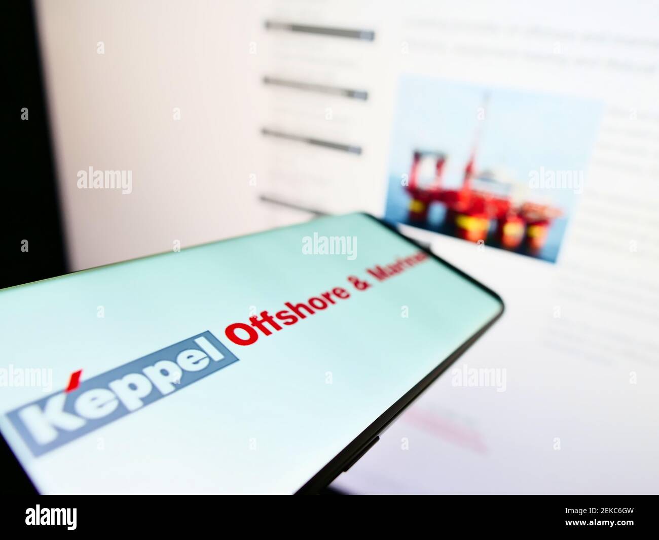 Mobile phone with logo of Singaporean company Keppel Offshore and Marine  on screen in front of business website. Focus on center of phone display. Stock Photo