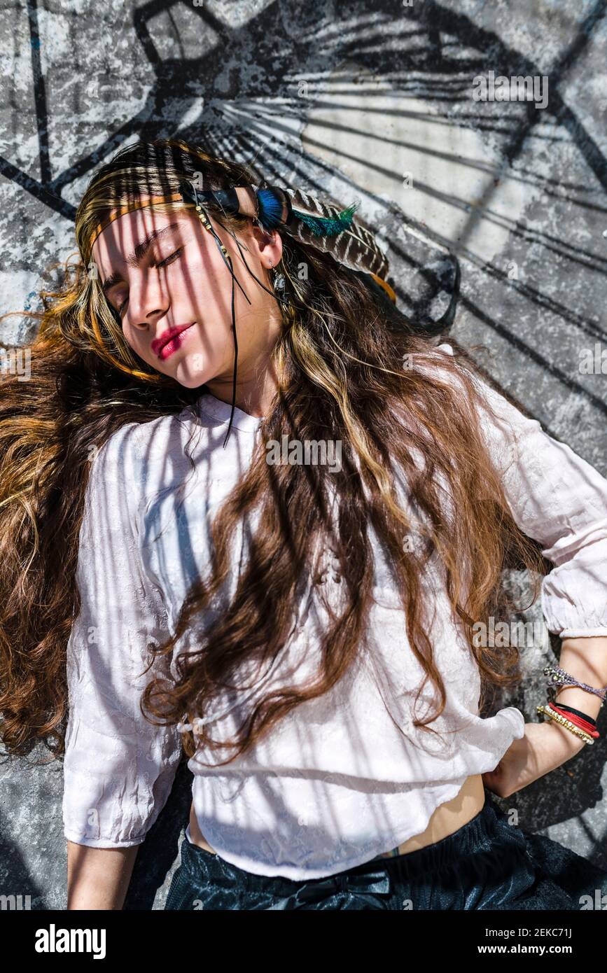 Close-up portrait of hippie woman gesturing against wall Stock Photo