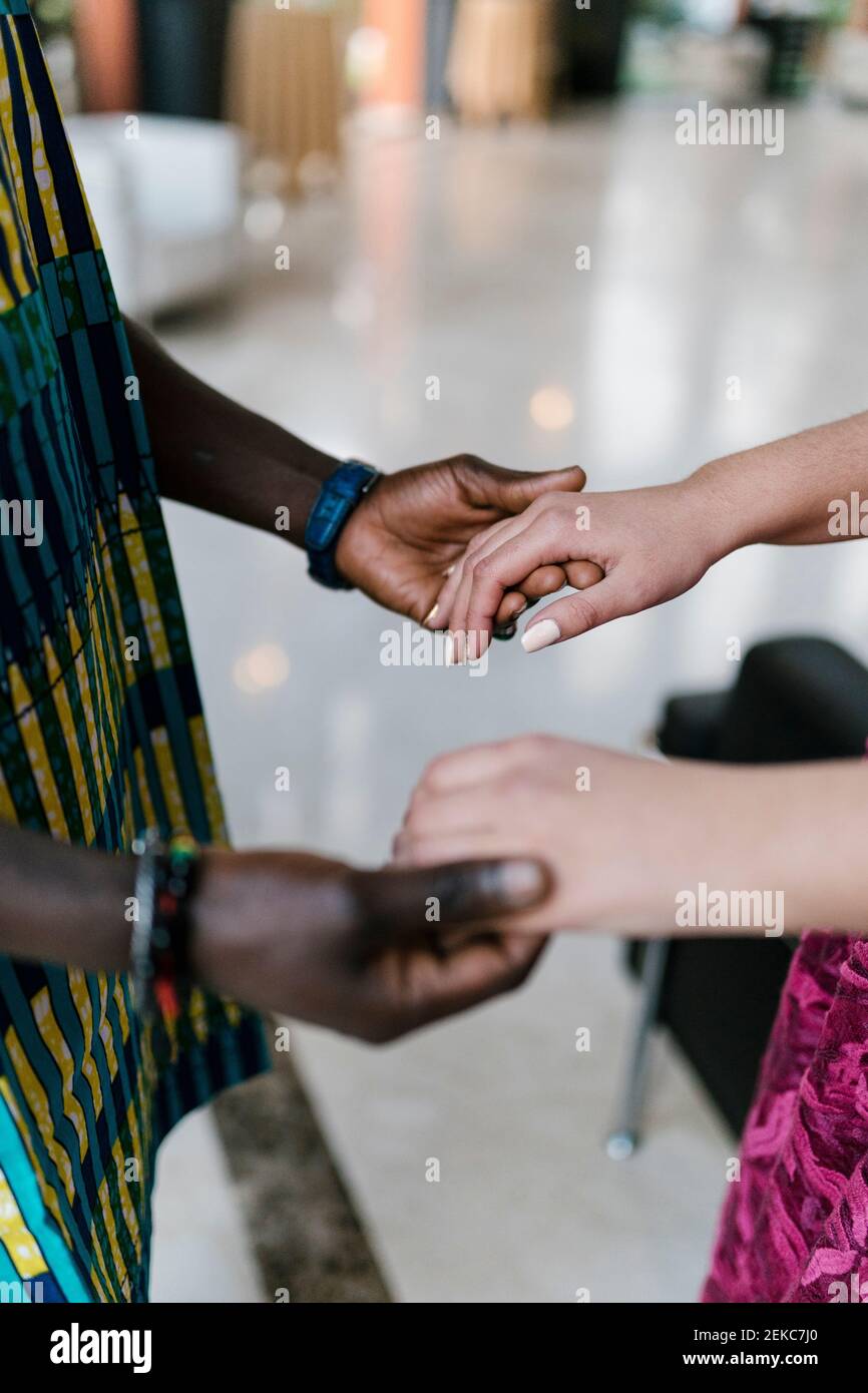Couple holding hands while standing at banquet Stock Photo