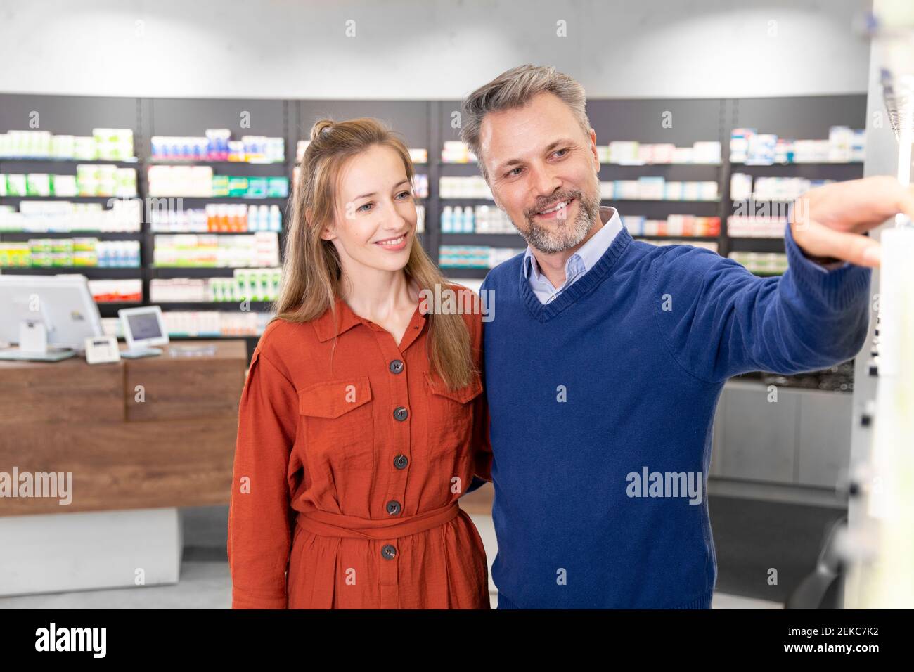 Smiling couple purchasing medicine at pharmacy Stock Photo