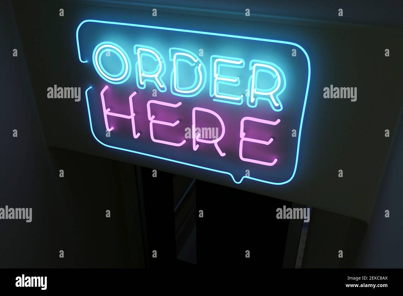 Illuminated order here text on black background Stock Photo