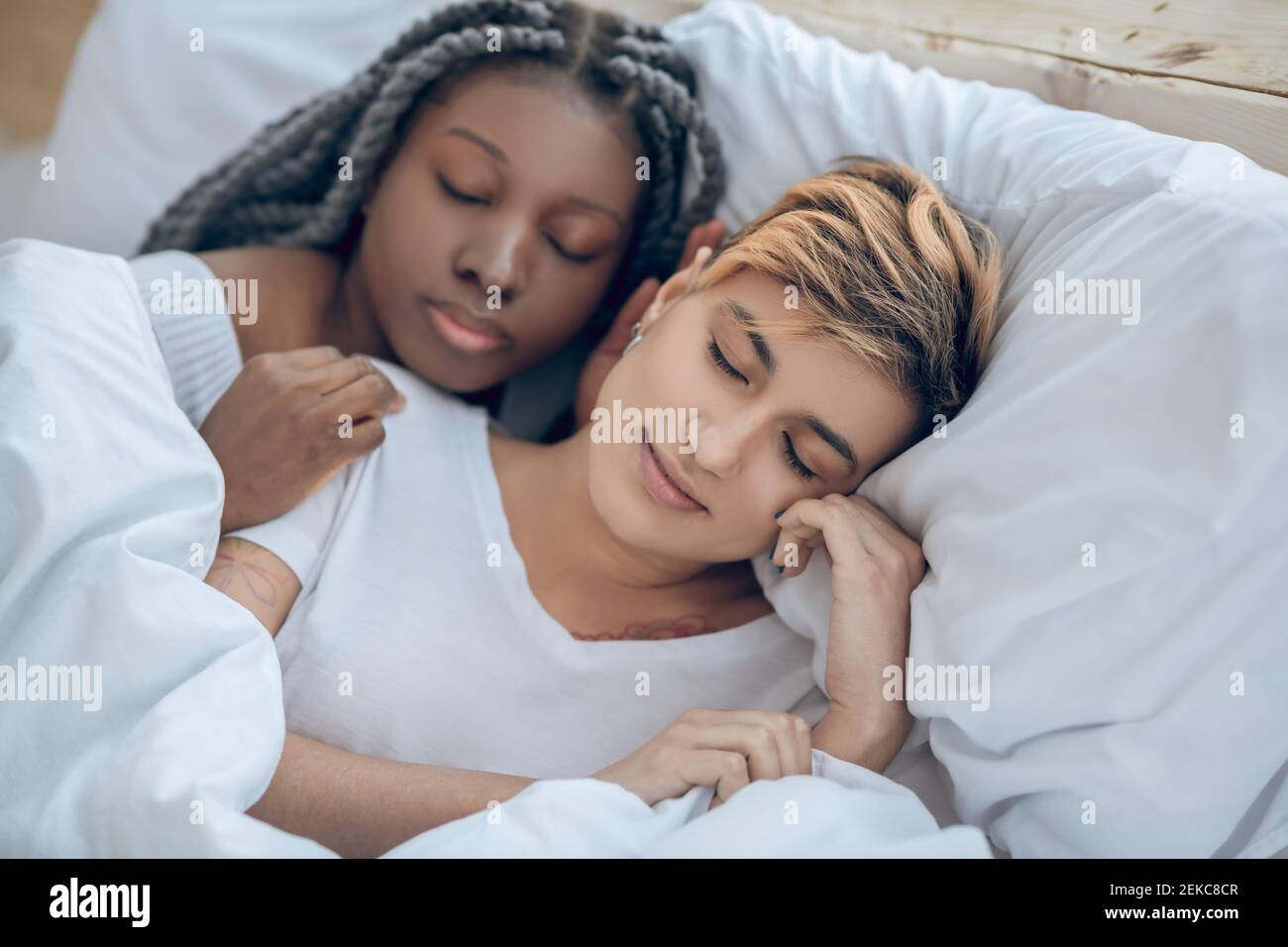 Two girls lying on the bed and sleeping Stock Photo Alamy