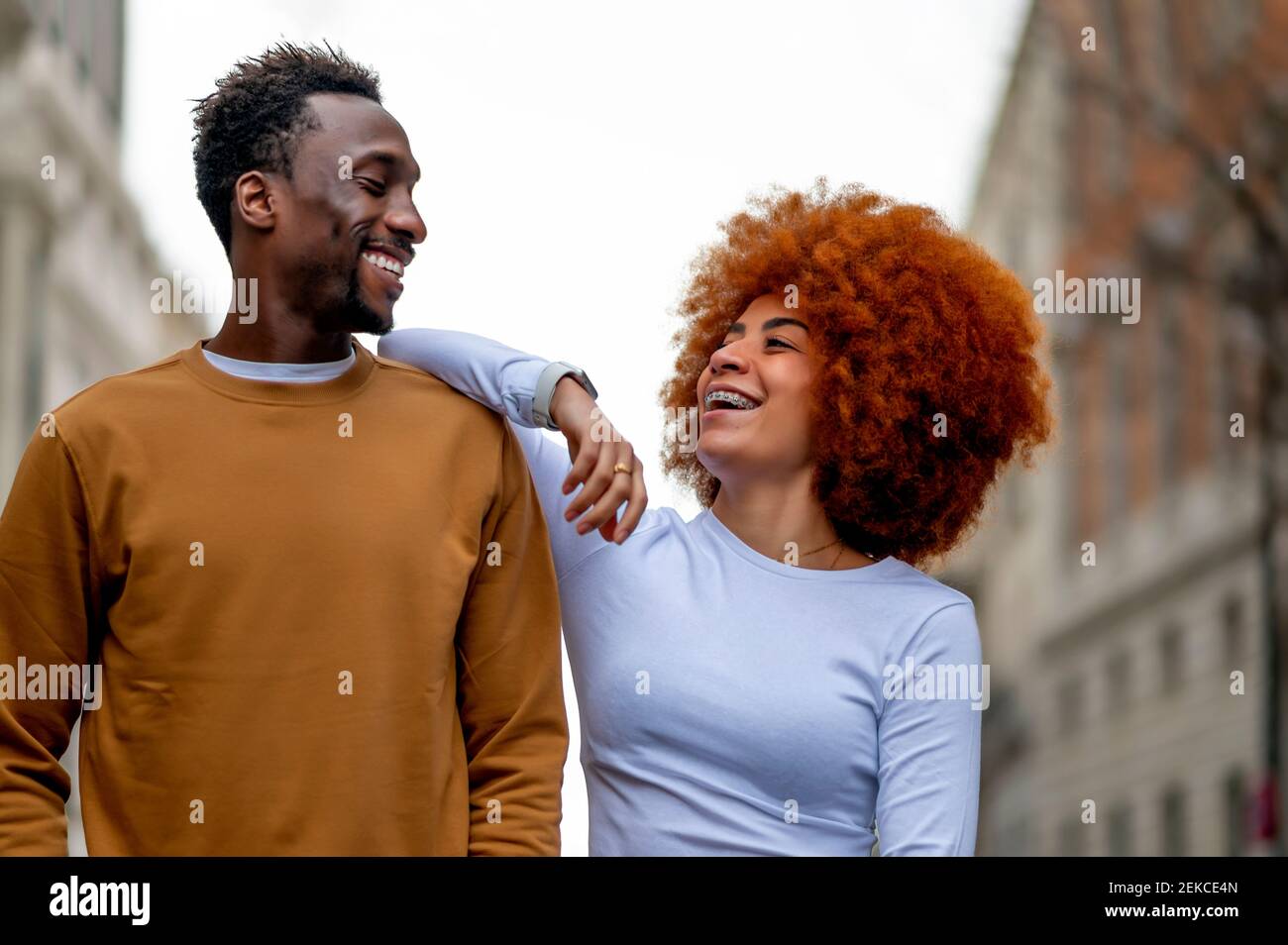 Happy couple looking at each other while standing outdoors Stock Photo