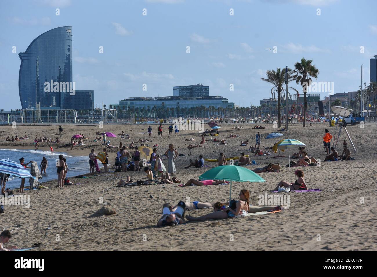 People enjoy the sun and the warm weather at Somorrostro beach. According to the National Statistics Institute (INE), just 204,926 international visitors arrived in Spain in June, a drop of 97.7% from the same month in 2019. In Catalonia region decreases to 72.5%. (Photo by Jorge Sanz / SOPA Images/Sipa USA)  Stock Photo
