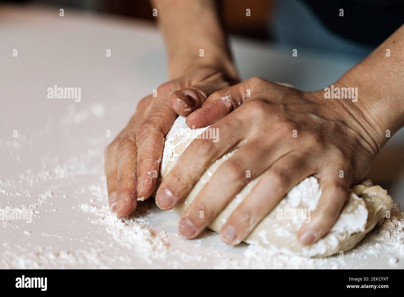 Woman kneading dough for cinnamon rolls Stock Photo