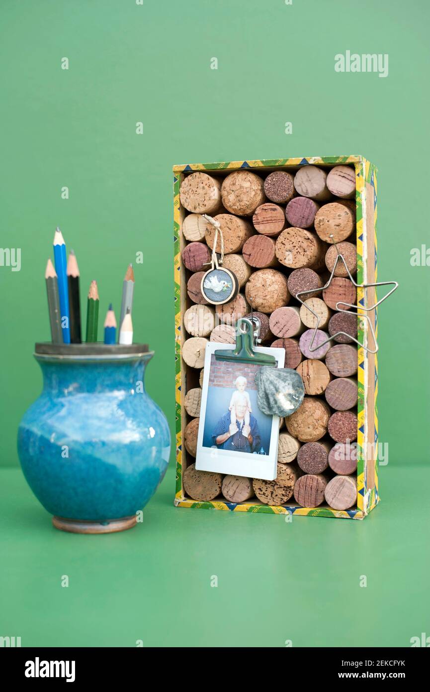 Vase with pencils and DIY bulletin board made of various corks Stock Photo