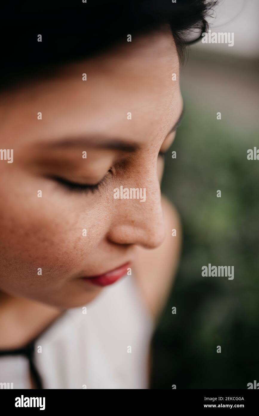 Mid adult woman with eyes closed Stock Photo