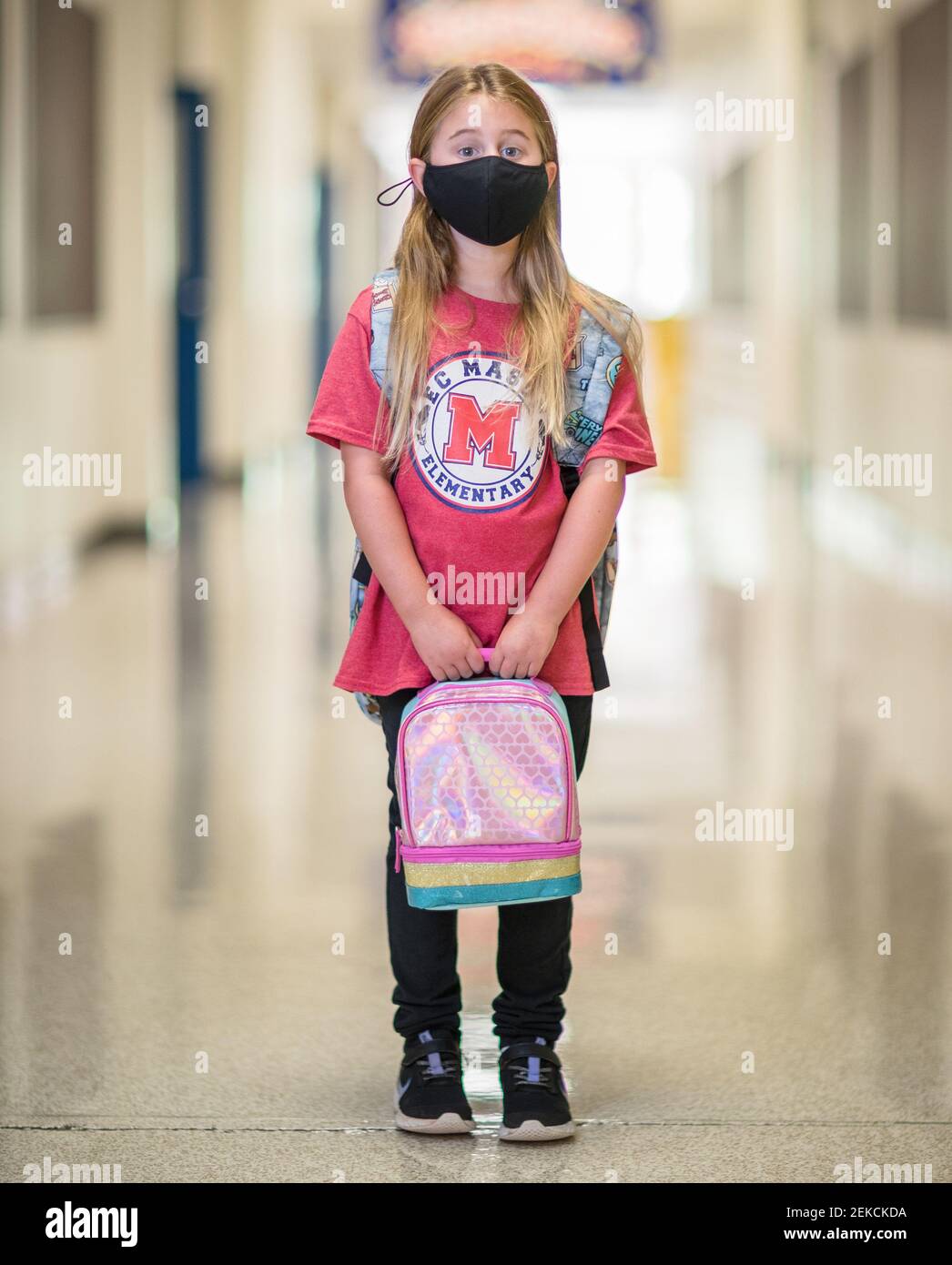 August 6, 2020 Donning a mask, second grader Avery Whitbeck prepares