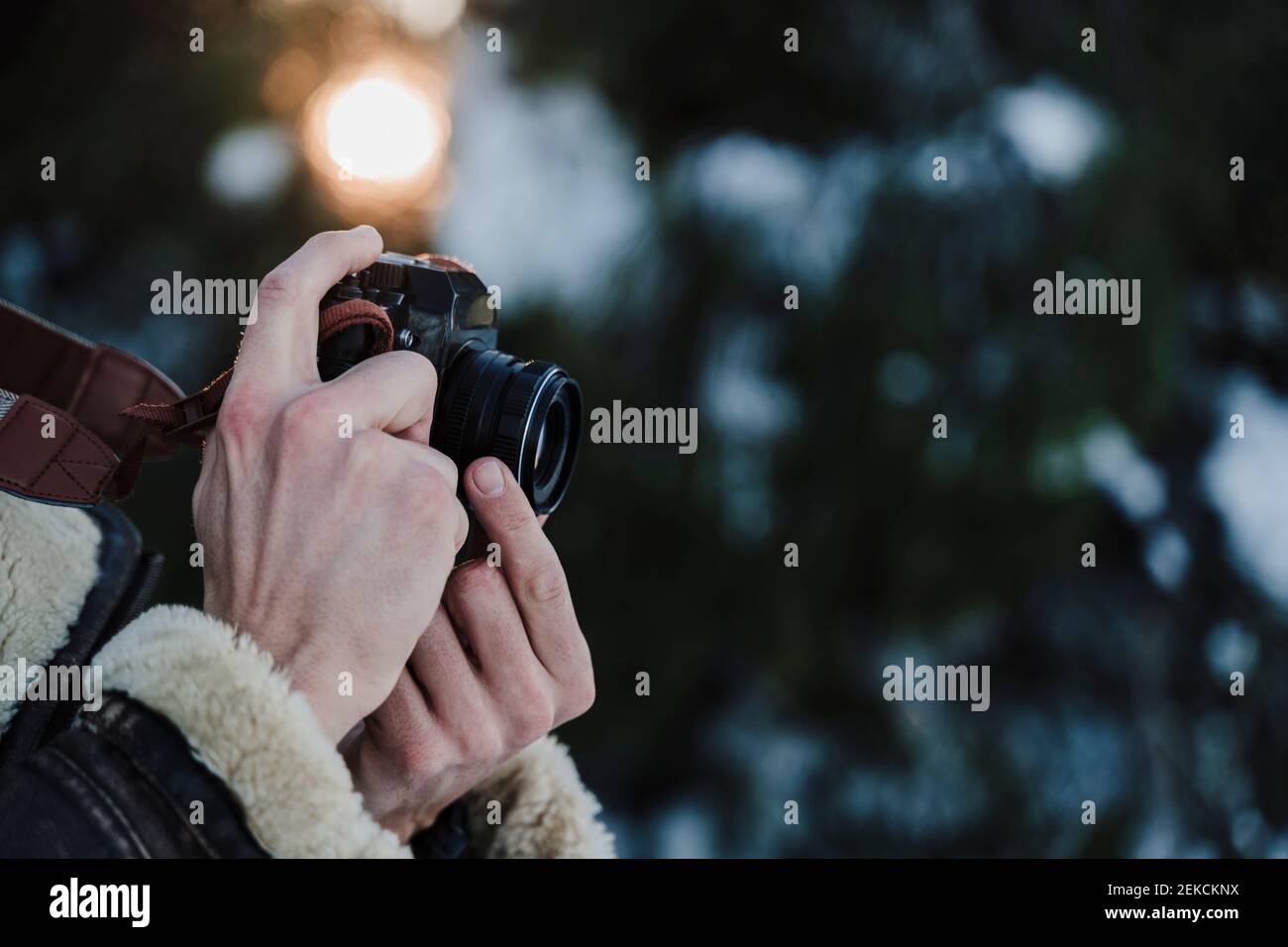 Man taking pictures with camera during winter Stock Photo