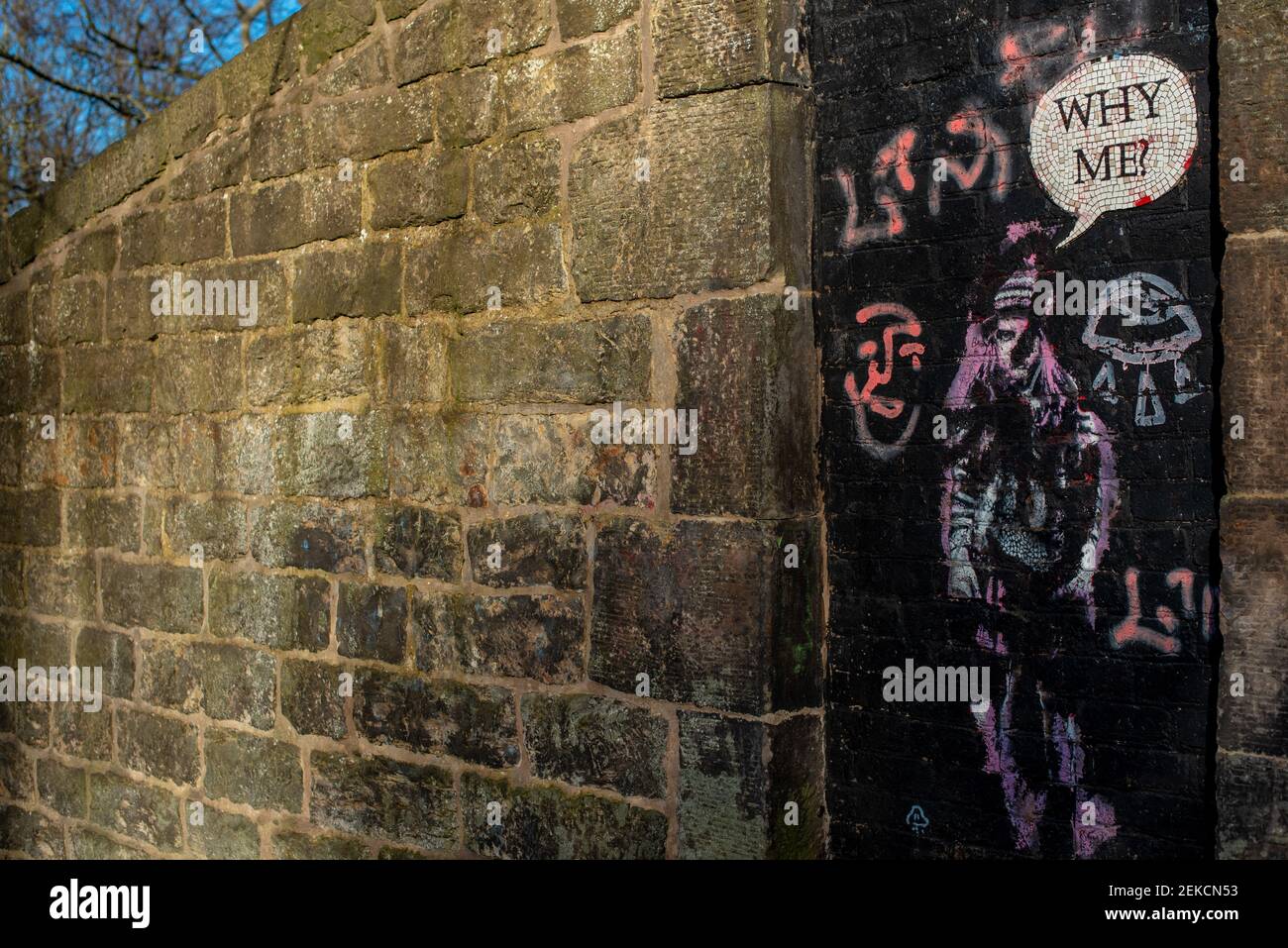 'Why Me' street art girl on door on next to brick wall on slopes of Calton Hill Edinburgh Stock Photo
