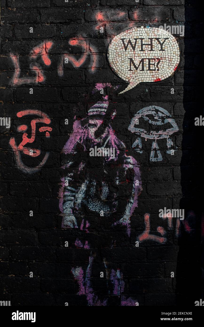 'Why Me' street art girl on door on next to brick wall on slopes of Calton Hill Edinburgh Stock Photo