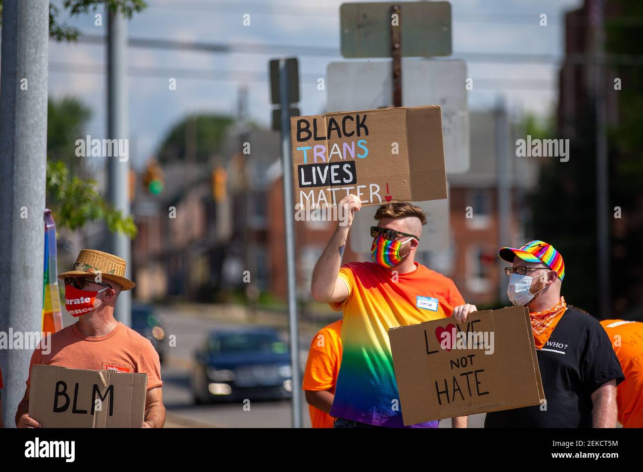 Demonstrators hold up signs during a Pride Rally in Milton ...